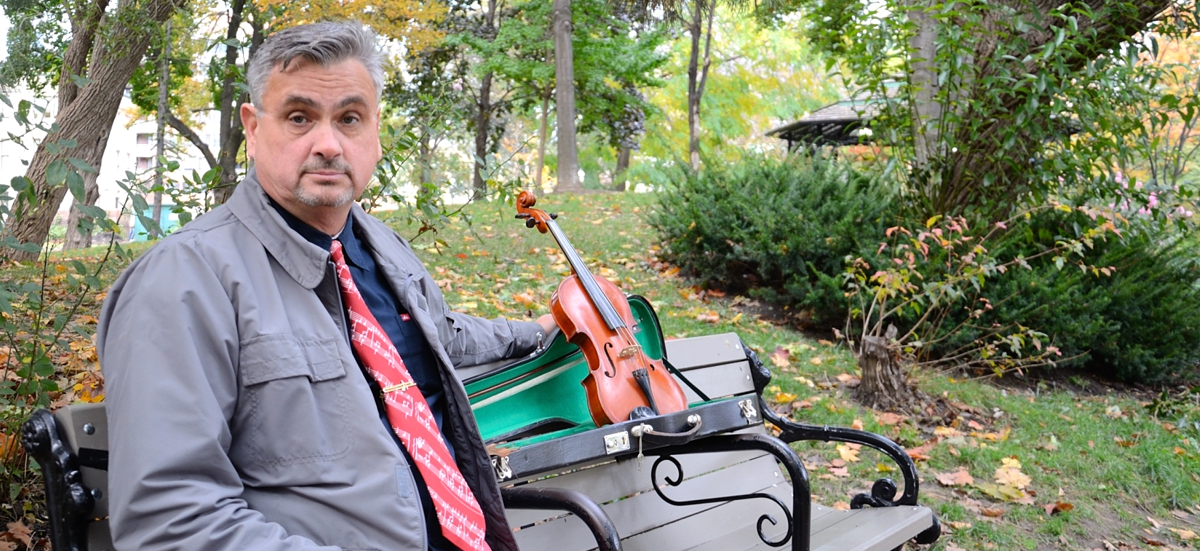 Resting on a downtown bench with Dad's violin during photo shoot for CD